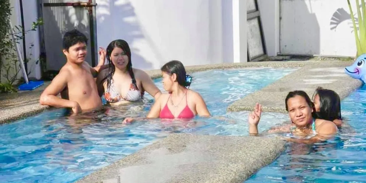 A group of people in the pool at a resort.