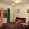 A bedroom with a bed, desk and chair.