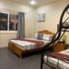 Bedroom with two beds and a bunk bed.