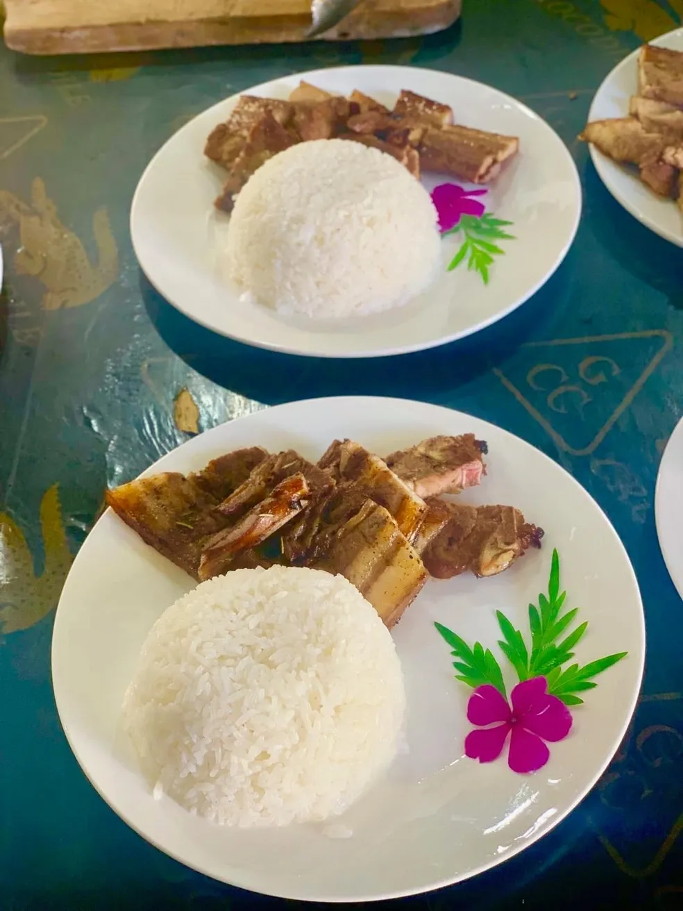 A plate of rice and meat on top of a table.