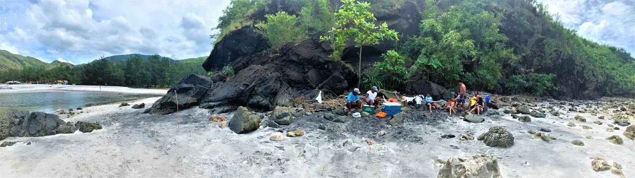A group of people sitting on the beach.
