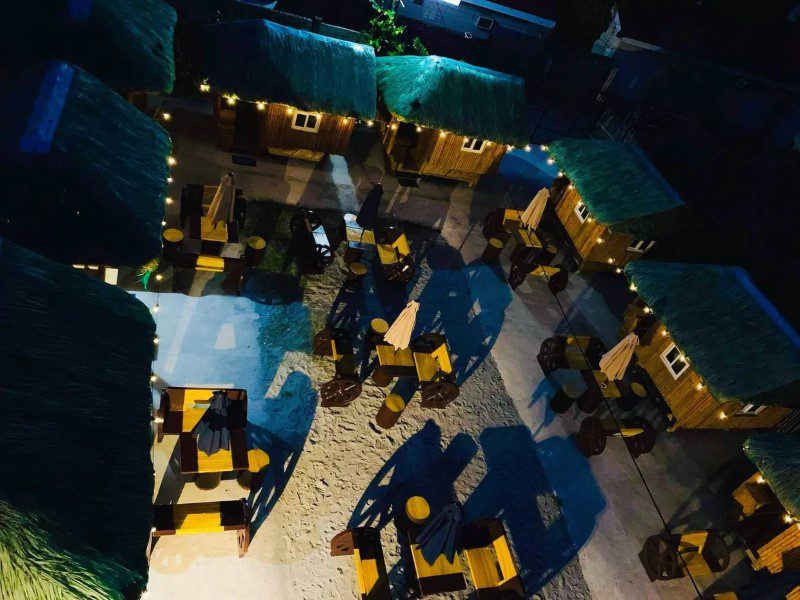 A view of an outdoor restaurant at night.