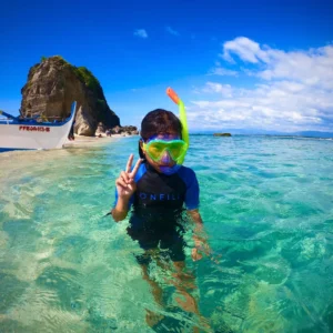 A person in the water with a mask and snorkel.