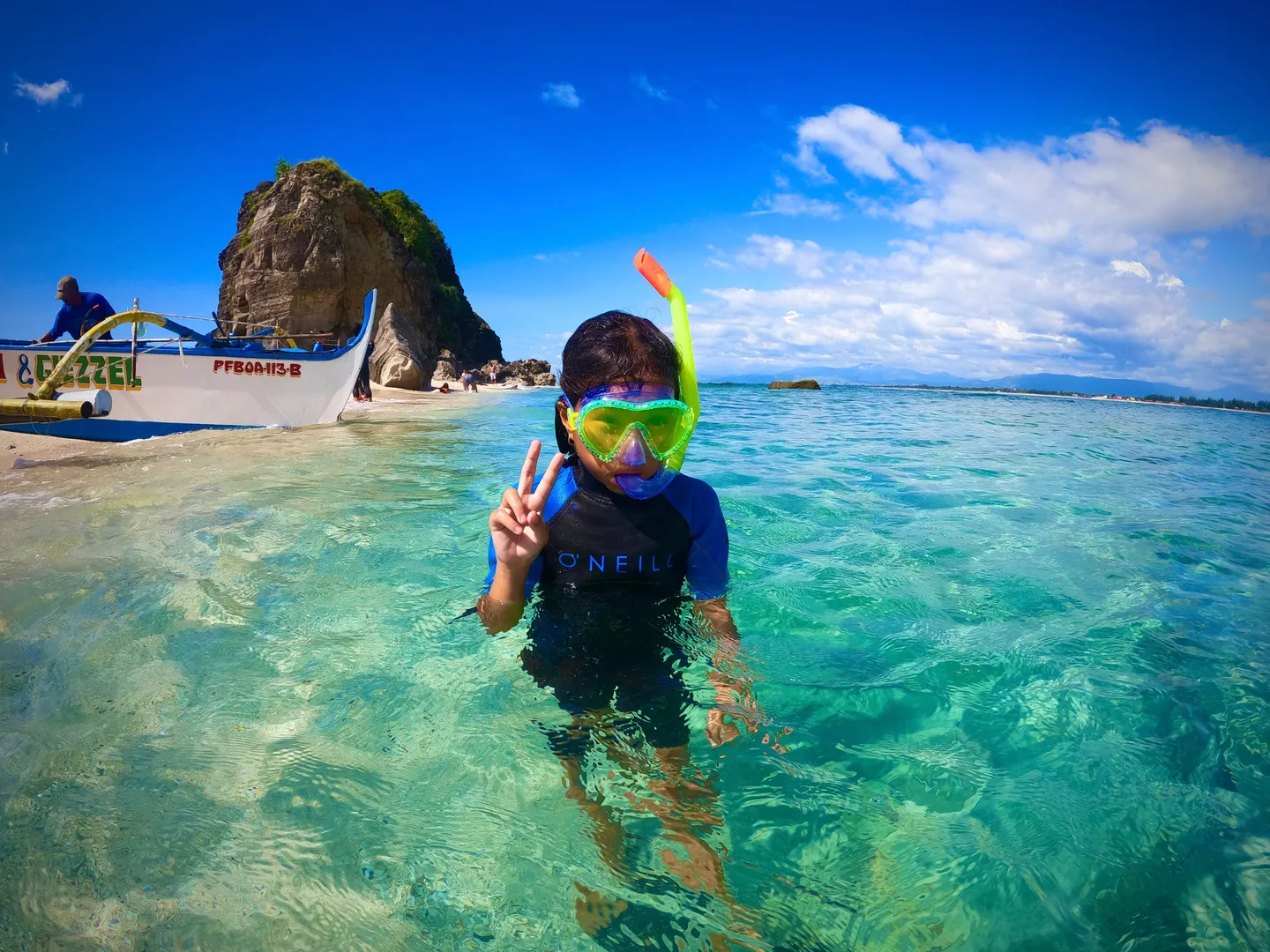 A person in the water with a mask and snorkel.