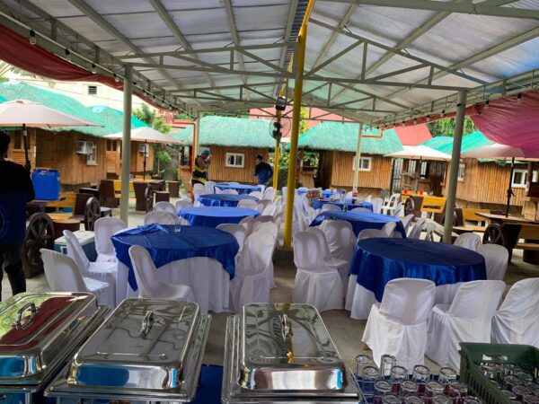 A party venue with blue and white tablecloths.